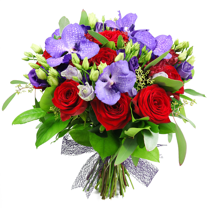 Against a pristine white backdrop, this bouquet unfolds with opulent depth, a masterful blend of deep red and purple hues. The red roses stand out boldly, their velvety petals spiraling into classic, heartful geometry. Purple Vanda orchids provide a striking counterpoint, their broad petals marbled with lilac speckles that hint at distant tropical gardens. Intertwined are lisianthus in lilac and indigo, adding soft contrast and gentle movement. The greens are abundant-glossy broad leaves with slender, fresh sprigs creating a lush frame that grounds the bouquet in a natural, garden-like atmosphere. Buds yet to open dot the arrangement, along with tiny filler greens that give texture and a sense of growth. The stems are neatly gathered and secured with a dark mesh ribbon, its net-like texture lending modern elegance to a traditional form. This display radiates romance and celebration, ideal for anniversaries, Valentine's gestures, or a refined gift to express admiration. Delivered by experienced florists in Bexleyheath, it would grace a dining room, a foyer, or a festive table with timeless charm, speaking to the area's love of thoughtful, long-lasting blooms along the Broadway corridor and near Hall Place.