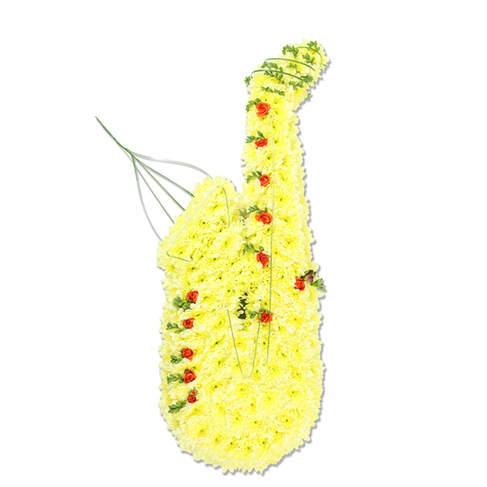 A large and meticulously detailed funeral tribute in the form of a saxophone stands upright against a stark white background, its strong silhouette instantly recognisable despite being made entirely from flowers. The surface of the saxophone is a dense blanket of bright yellow chrysanthemum blooms, each small floret tucked so closely beside its neighbours that the result is a soft yet structured skin of petals tracing every curve from the mouthpiece, down the sweeping neck, along the straight body, and into the flared bell. This sunlit yellow is punctuated by petite red rosebuds placed deliberately along the length, where the finger keys and pads of the instrument would sit, adding visual rhythm and dimension. Their velvety petals and deeper colour give the illusion of metal details picked out along a golden tube. Interwoven among the chrysanthemums are slender strands of rich green foliage, perhaps ivy or another trailing greenery, wrapping naturally around the edges and through the bends, suggesting the complexity of the saxophone's structure while lending an organic, slightly informal touch. Near the top, around the mouthpiece area, thin metallic or green wires are just visible, lifting gently upwards like the suggestion of reeds or faint musical notes. The lighting is bright and even, casting almost no shadows, so the rich textures and colour contrasts are clearly defined. This design has the feel of a bespoke piece made for a Bexleyheath family wishing to honour a loved one's passion for music, whether from local community bands or evenings spent listening to jazz at home. The yellow chrysanthemums evoke comfort, remembrance, and the glow of shared memories, while the red roses carry a quiet message of love and respect, making this floral saxophone a meaningful tribute for services across Bexleyheath.