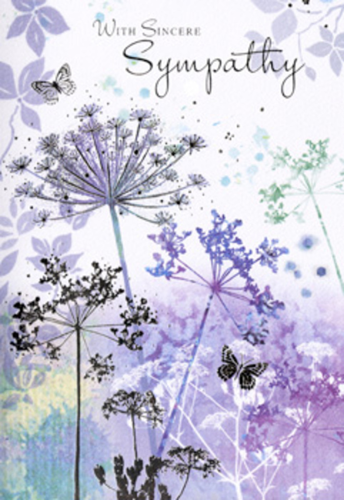 There is a calm, almost prayerful stillness to the illustration inside this sympathy card, one that echoes the peaceful corners around Bexleyheath where people pause and reflect. Slender wildflower stems rise gracefully from the bottom edge, each one crowned by finely detailed umbels that spread outward like tiny constellations. The flowers are captured in soft, layered washes of lavender, dusky violet, and cool blue, with hints of silvery green along the stems that subtly anchor the palette. The technique feels very much like hand-painted watercolour-pigment gently pooling and fading so that no single line is too sharp, mirroring the blurred edges of memory that often accompany loss. Behind the flowers, a background of misty purples and powder-blues drifts across the surface in uneven patches, suggestive of distant meadows viewed through a gentle haze, not unlike the soft horizons seen beyond Danson Park or the quieter streets off Broadway. Floating with effortless grace, a few butterflies weave between the heads of the blooms. Their wings are pale and translucent, drawn with just enough detail to show their form without disturbing the card's quiet mood. They evoke the sense of a soul in motion, of continuity and transformation, offering a quiet counterpoint to sorrow. The composition itself is carefully balanced: the taller stems lean slightly, while shorter ones fill the gaps, much like a thoughtfully arranged sympathy bouquet displayed in a Bexleyheath home. Nothing competes, nothing shouts; it is all hushed and harmonious. This makes the card a meaningful accompaniment to fresh condolence flowers, providing a visual space where grief can rest and be gently held, surrounded by the enduring grace of nature.