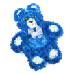 On a bright, uncluttered white background, a floral teddy bear takes centre stage, its entire form designed to echo the warmth of a cherished soft toy while being made wholly from fresh flowers. The bear's body is constructed from tightly packed royal blue blooms, probably chrysanthemum-type flowers, their small petals layered closely to create a thick, plush-like surface. The deep blue is consistent across the head, tummy, arms, and legs, yet the natural variations in petal texture and direction give a sense of movement and softness. Creamy white and soft yellow flowers mark out the bear's most tender details: they line the inner parts of the rounded ears, form a rounded pale muzzle in the centre of the face, and create oval pads on each of the four paws, mimicking the stitched pads of a classic teddy. Two dark, reflective eyes with black pupils are positioned above a black, inverted triangle nose, and a fine curved line of a mouth completes an expression that feels gentle, watchful, and full of quiet comfort. Around the neck, a sheer white organza or mesh bow is tied neatly, its light, ruffled edges resting delicately against the blue petals and adding a refined, almost ceremonial touch. The bear is set at a slight tilt, giving the arrangement a dynamic yet peaceful presence, as though it is leaning in to offer reassurance. In Bexleyheath, this floral teddy bear is often selected as a special tribute for funerals or memorials, delivered to addresses near the Broadway, local churches, or family homes, especially to honour a baby boy or child with flowers that speak of serenity, remembrance, and the tender embrace of the community.